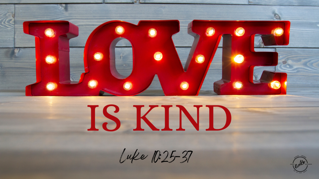 A lighted sign that says love is kind.