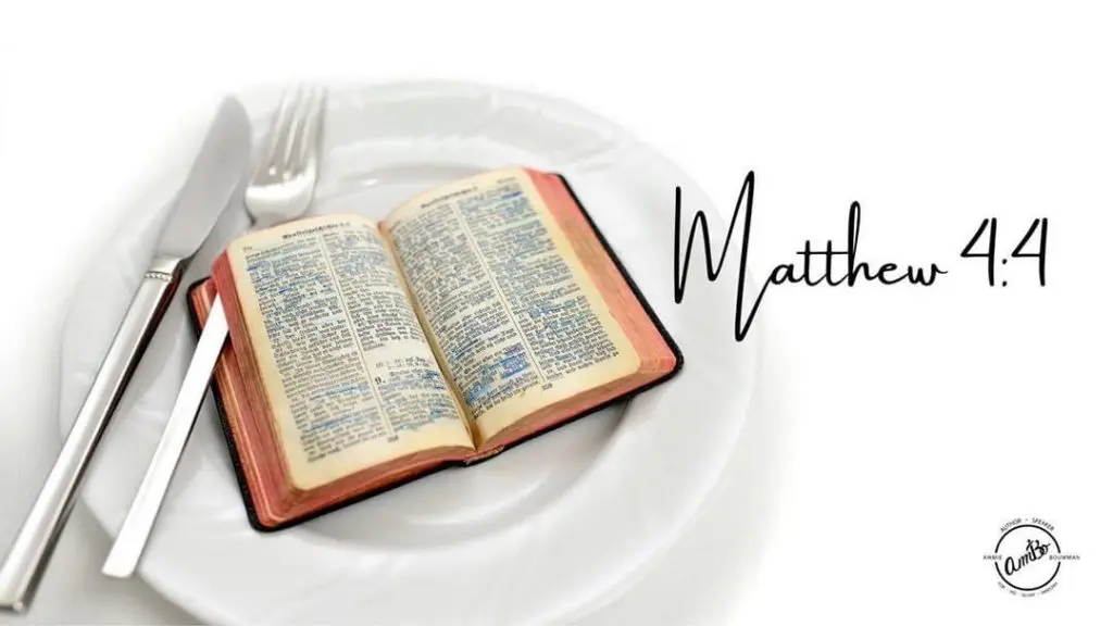 A fork and an open bible on a plate.