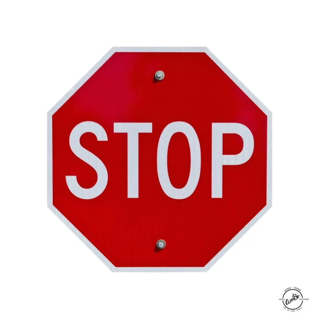 A red stop sign with white lettering.