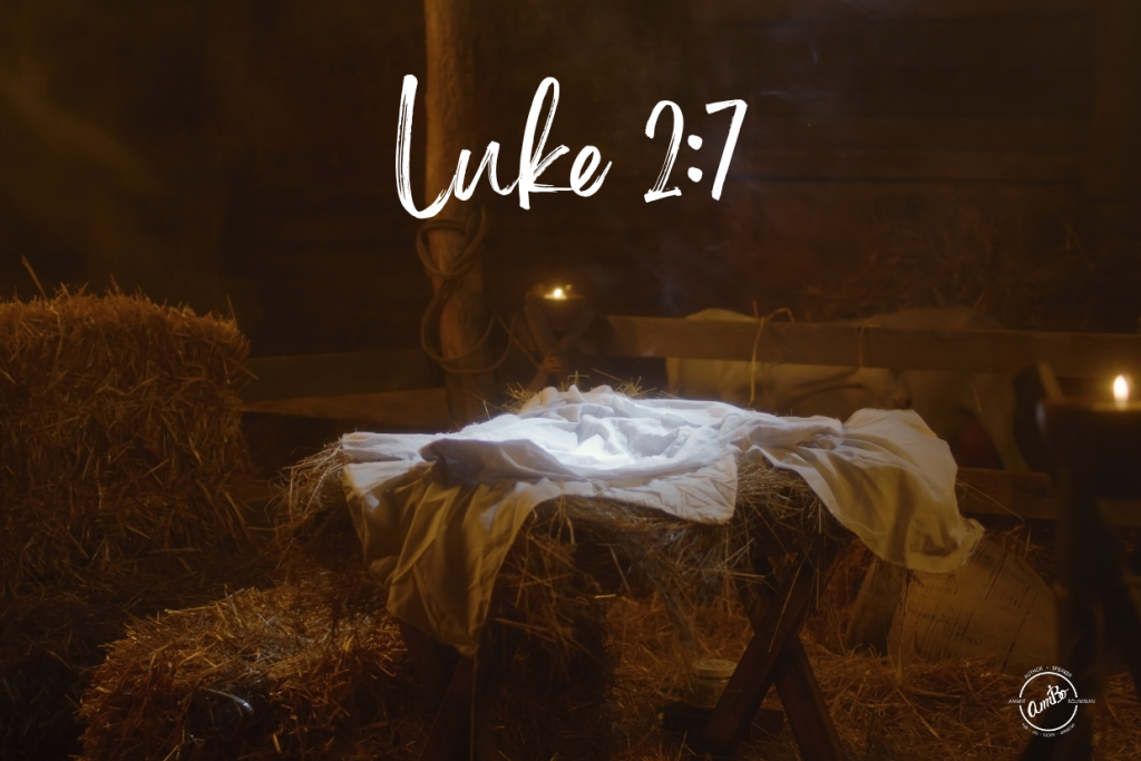 A manger scene with the word luke 2 : 7 written on it.