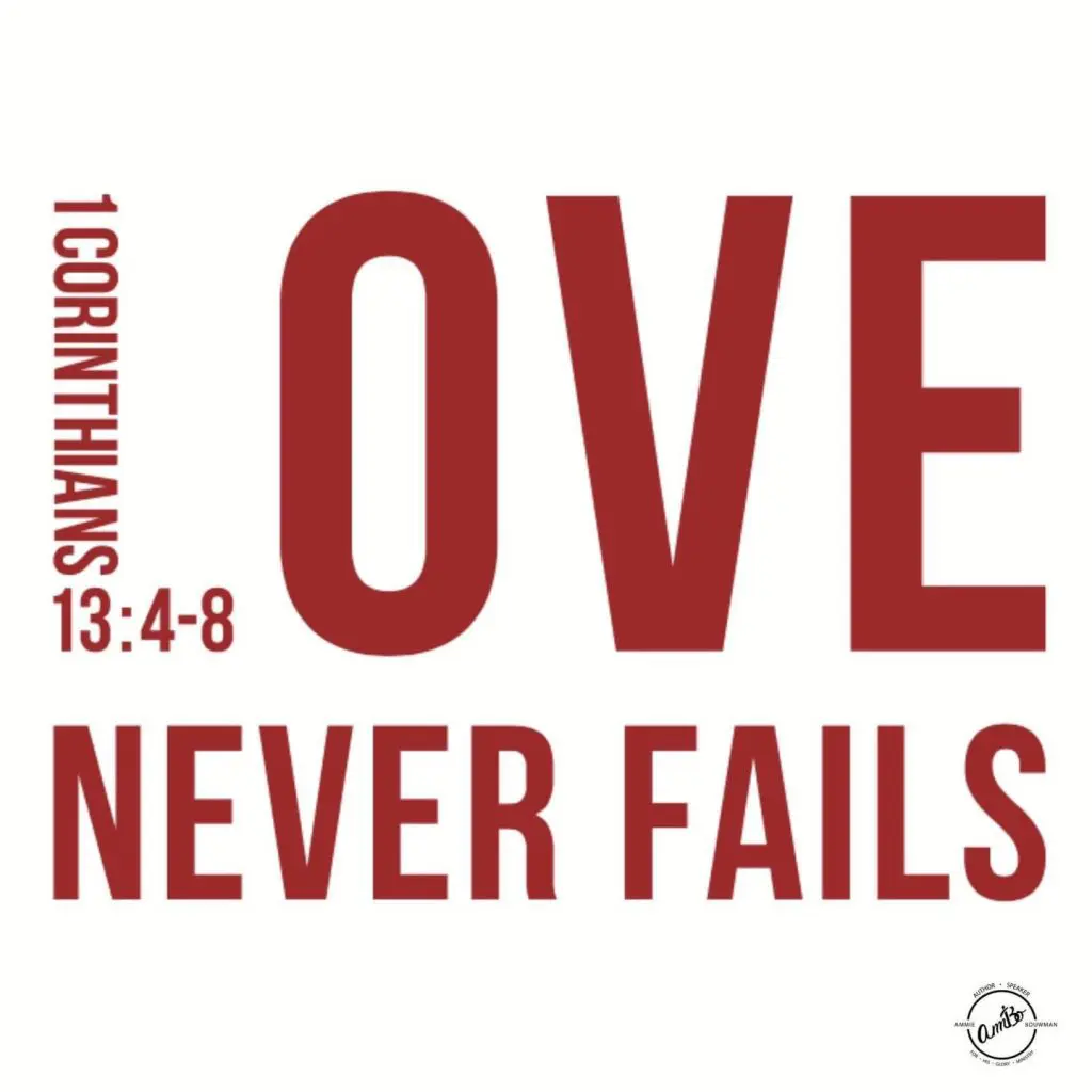 A red and white poster with the words love never fails