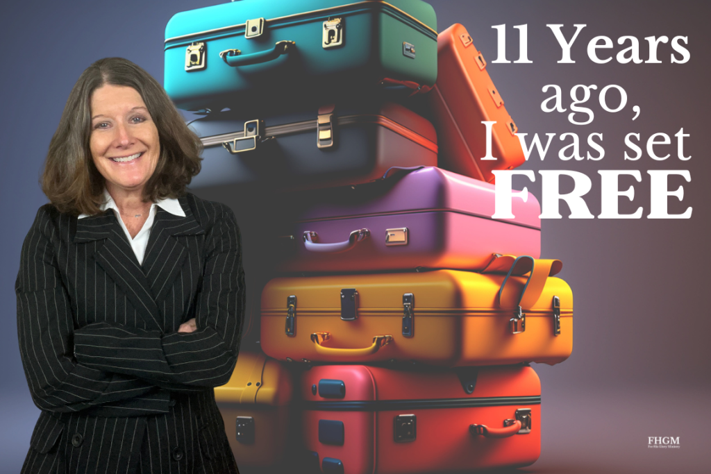 A woman standing in front of a bunch of suitcases.