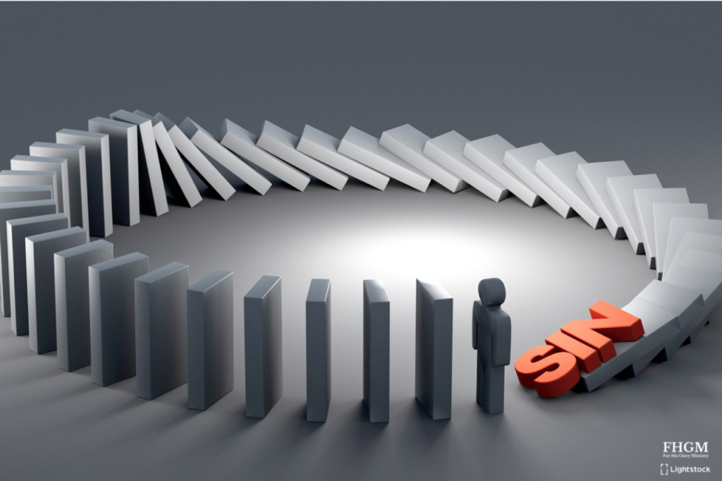 A man standing in front of a row of dominoes.