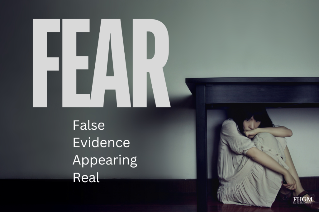 A person sitting in front of the word fear.