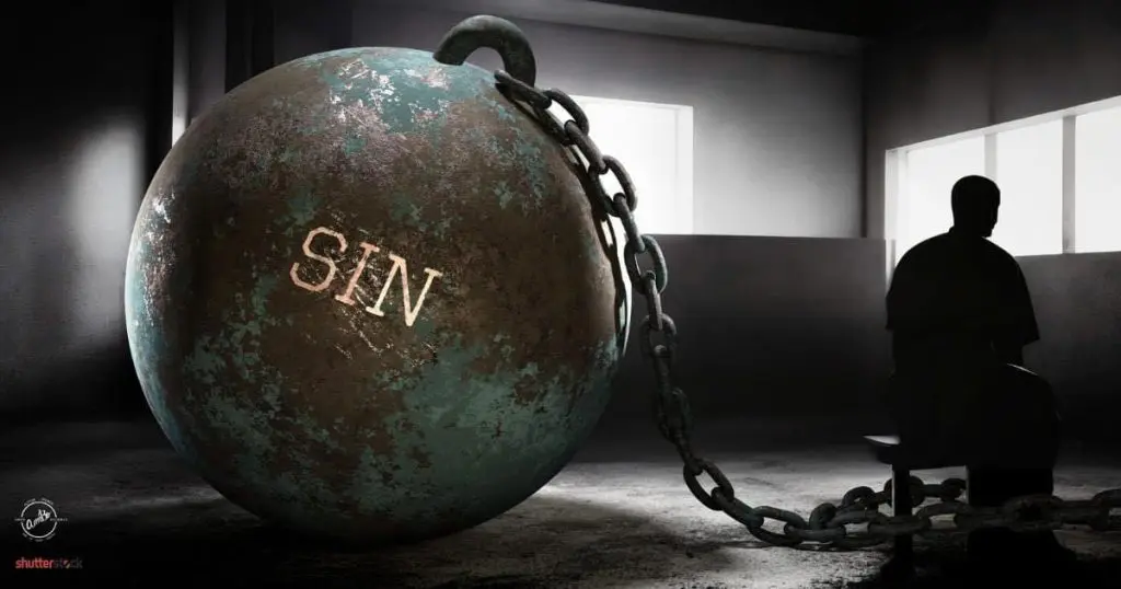 A ball and chain with the word sin written on it.