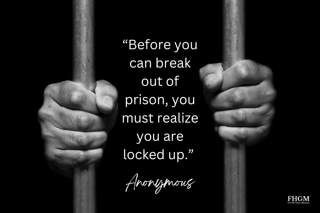 A person holding onto bars with the words " before you can break out of prison, you must realize you are locked up ".