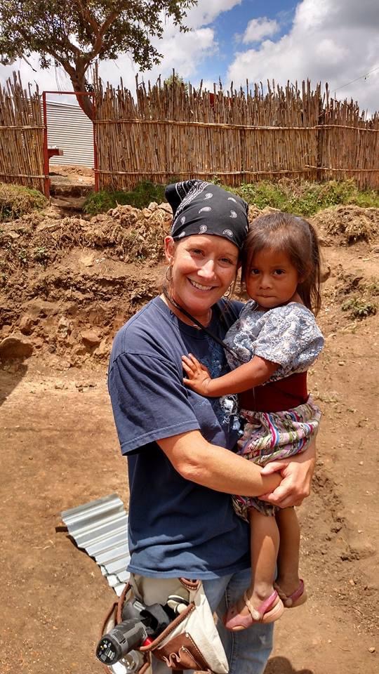 A woman holding a child in her arms.